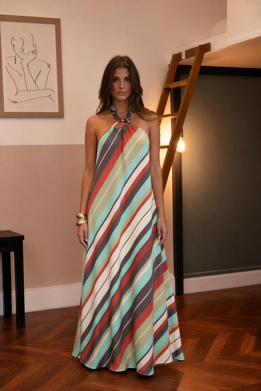 Front view of woman wearing multi-color striped halter maxi dress