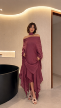 Front view of mauve off-shoulder draped maxi dress with matching choker neckline and handkerchief hem