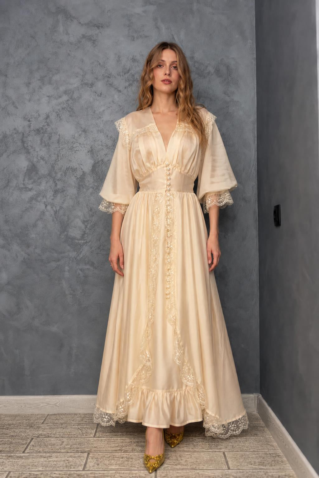 Model wearing cream vintage lace maxi dress from the front