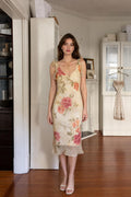 Front view of woman wearing cream floral ruffle midi dress
