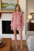Model wearing red paisley print two piece set front view