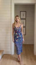 Front view of model wearing blue sequin floral midi slip dress
