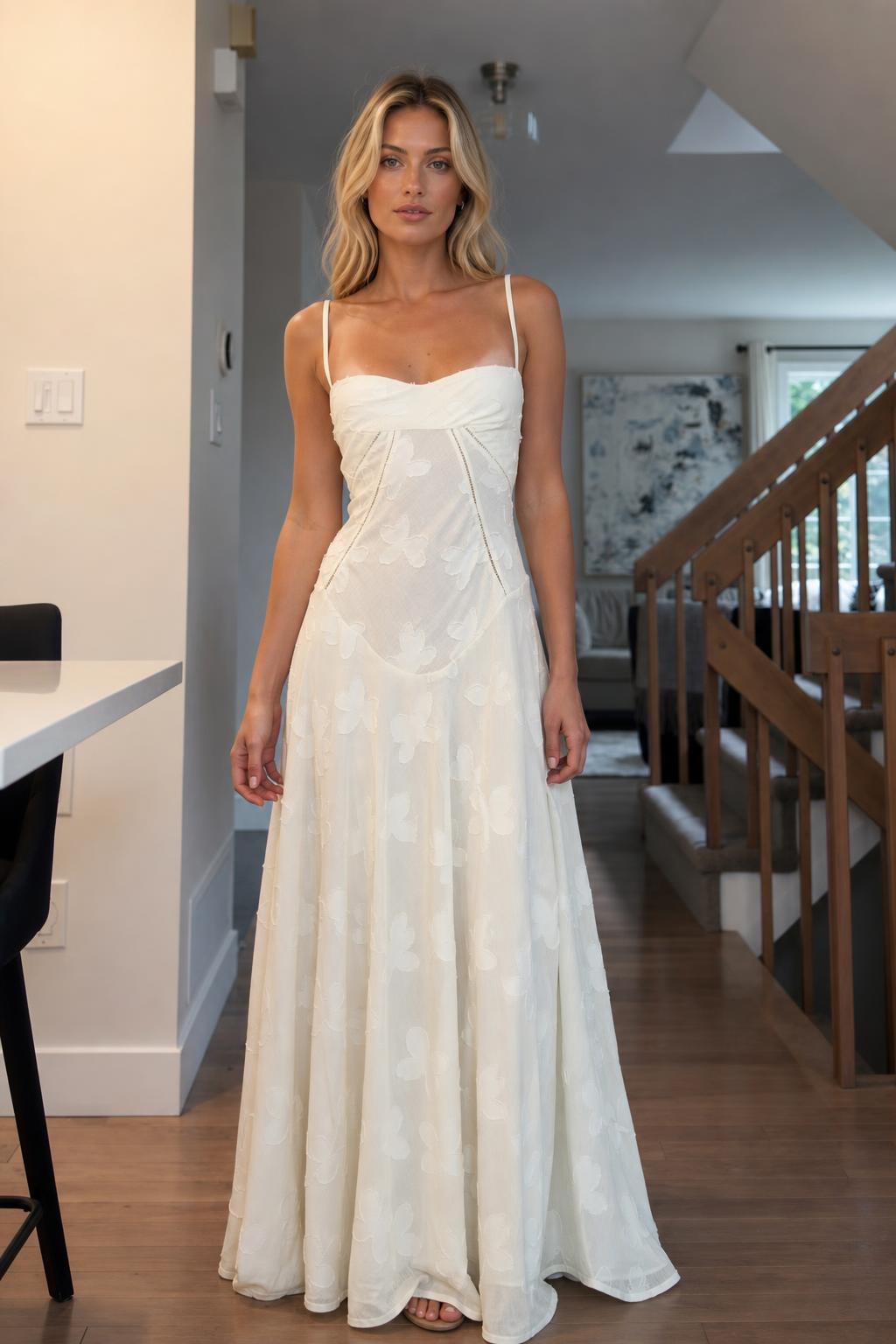 Front view of woman wearing white floral jacquard maxi dress