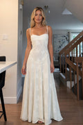 Front view of woman wearing white floral jacquard maxi dress