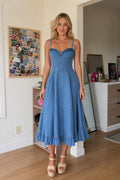 Front view of woman wearing blue denim midi dress