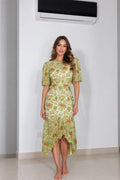 Front view of woman wearing green floral lace high-low midi dress