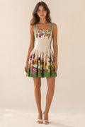 Front view of model wearing beige botanical floral print mini dress