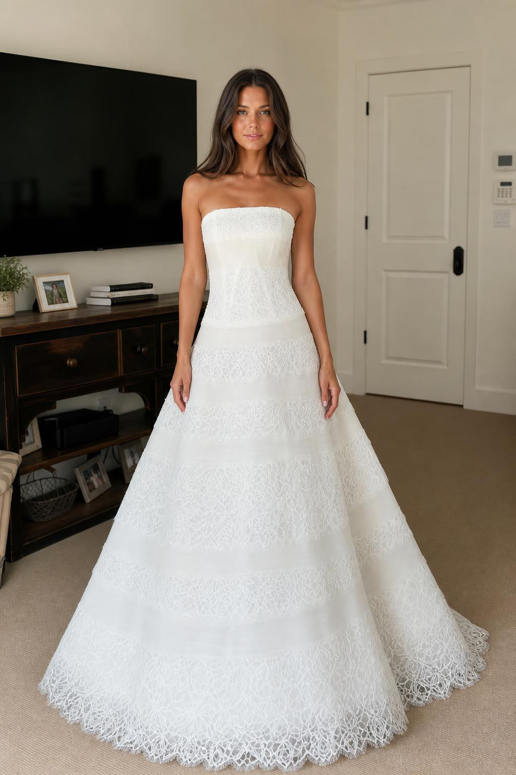 Front view of white strapless tiered lace evening dress