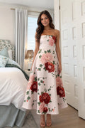 Front view of woman wearing pink floral strapless midi dress