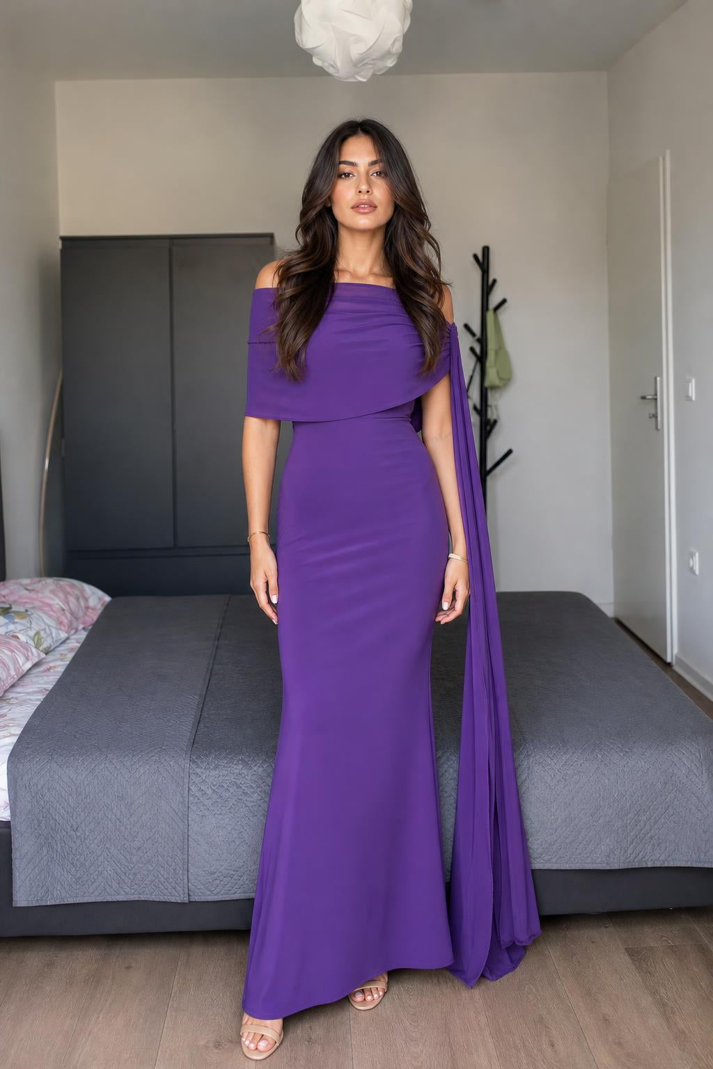 Model wearing purple off-shoulder cape maxi dress front view