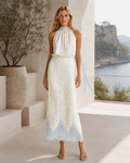 Front view of ivory printed halter midi dress with powder blue scalloped hem