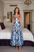 Model wearing blue ikat print midi dress with butterfly appliques front view