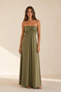 Woman wearing olive green strapless ruched maxi dress front view