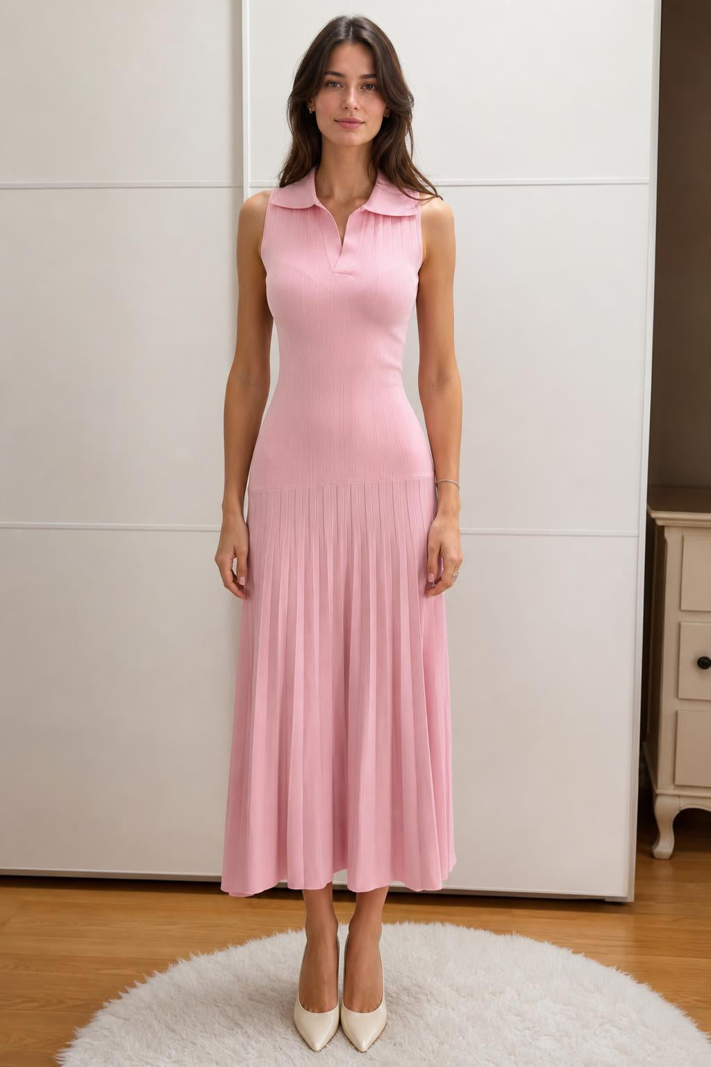 Front view of woman wearing pink sleeveless polo knit midi dress