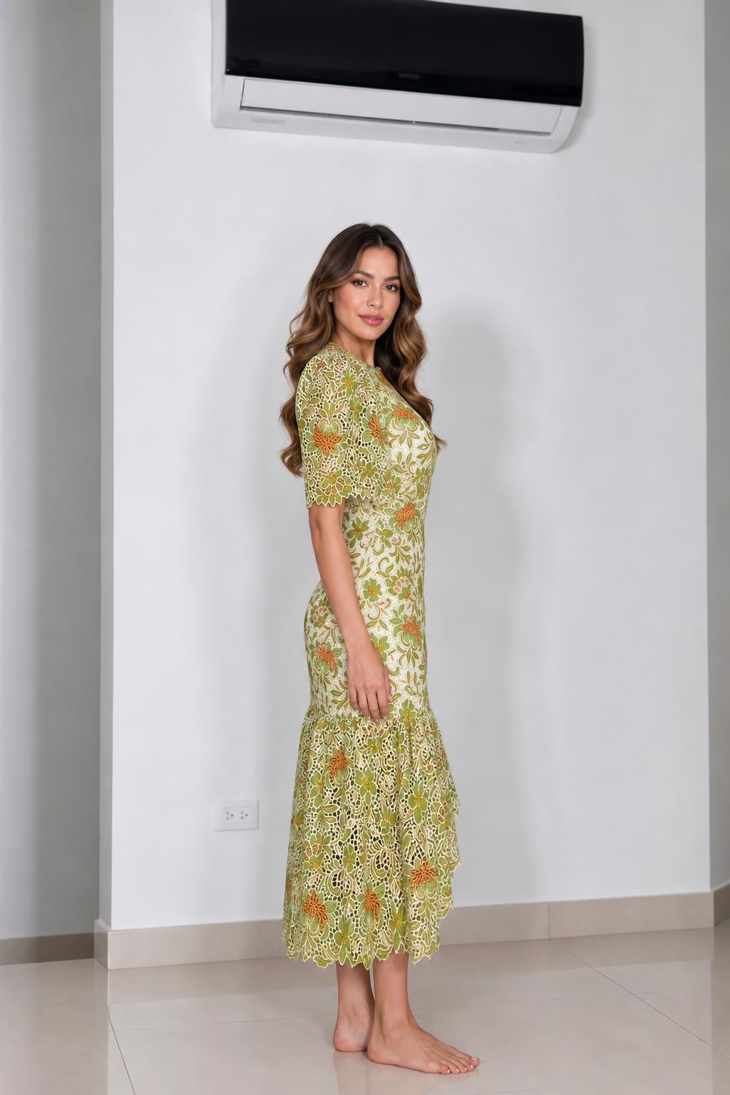 Side profile view of green floral lace midi dress