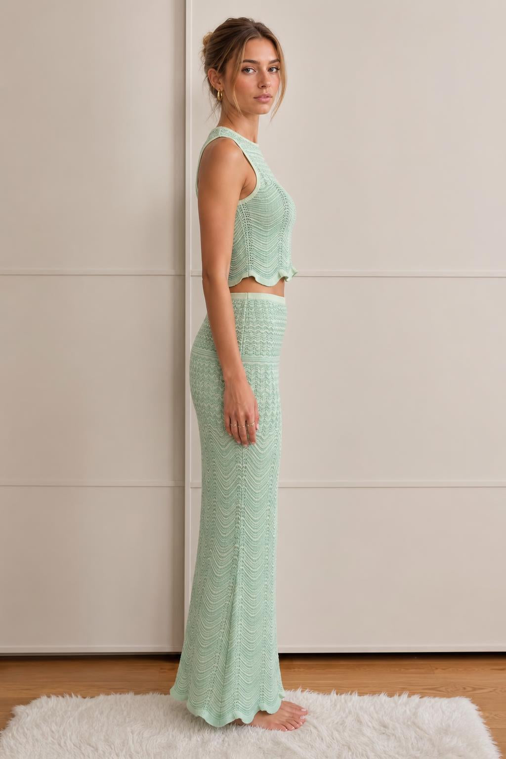 Model wearing mint green knit set, side profile view