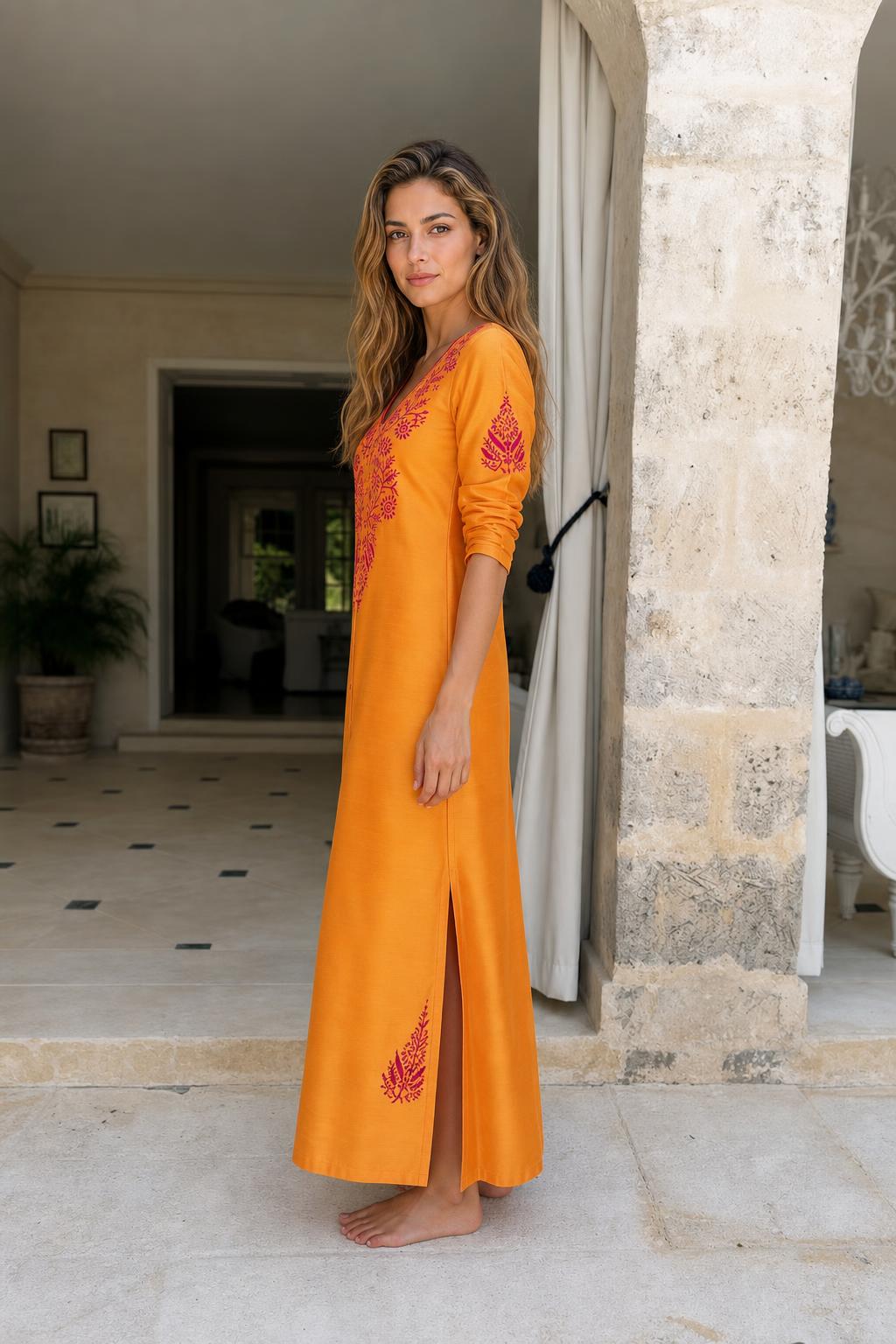 Side view of model in yellow maxi dress showing side slit