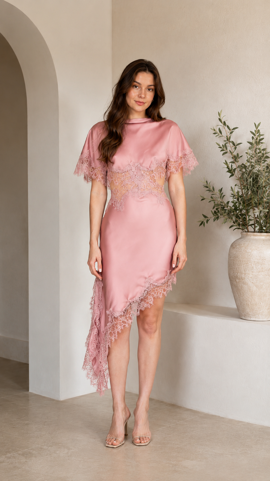Front view of blush pink asymmetrical midi dress with lace bodice detail and lace hem