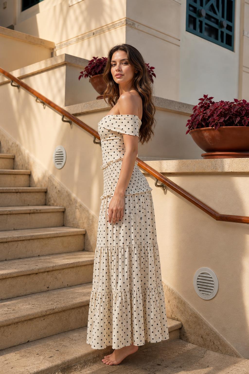 Model wearing cream polka dot maxi dress, side profile