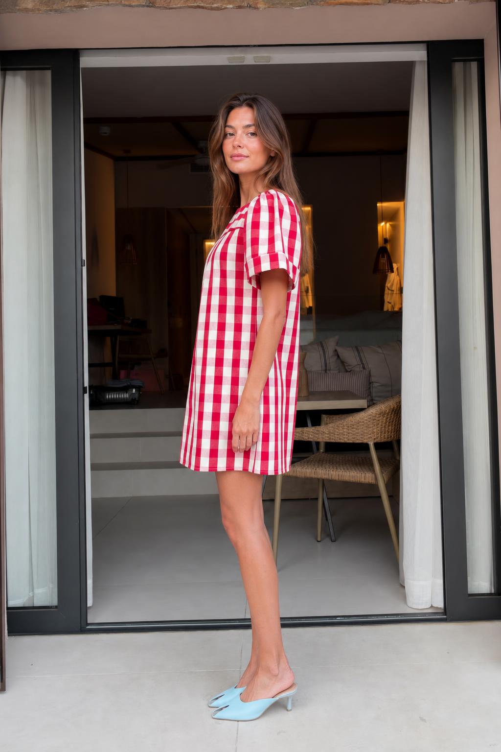 Side view of woman wearing red gingham check mini dress