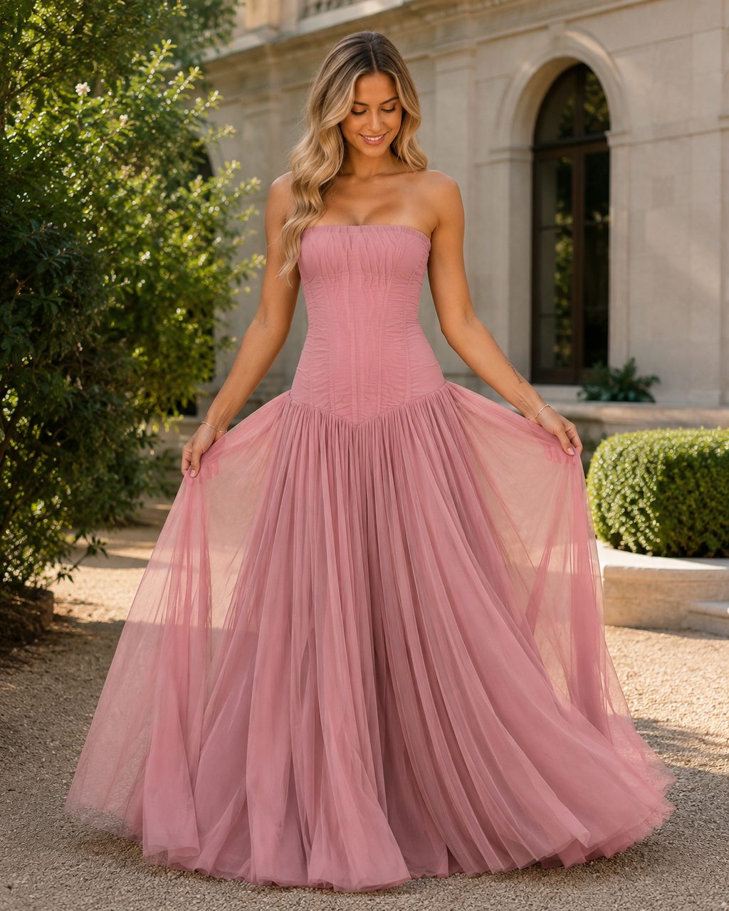 Front view of dusty rose strapless corset-style tulle maxi gown with gathered skirt