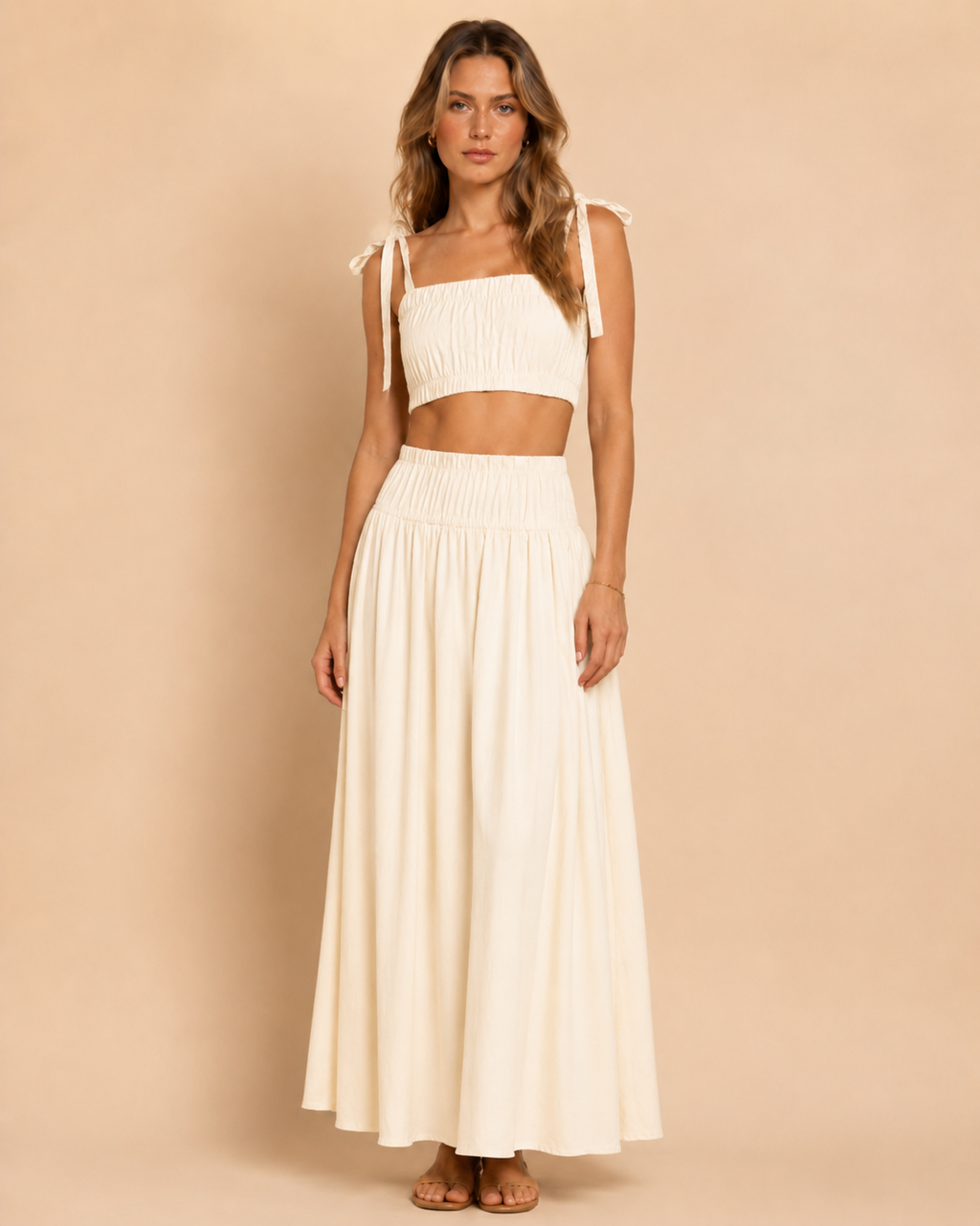 Front view of ivory smocked tie-shoulder crop top and matching maxi skirt set