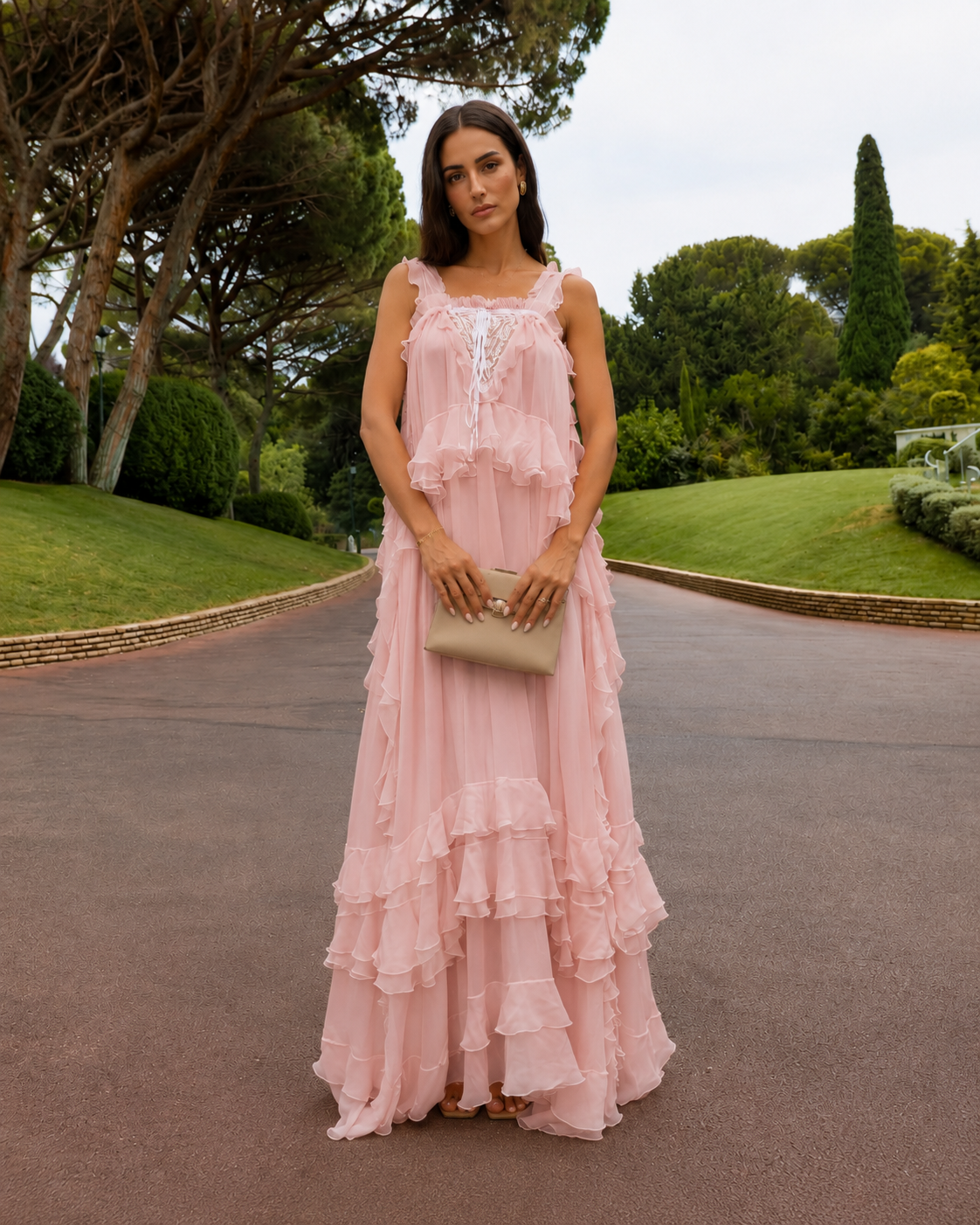 Front view of blush pink flowing maxi dress with lace-look bodice and ruffle layers