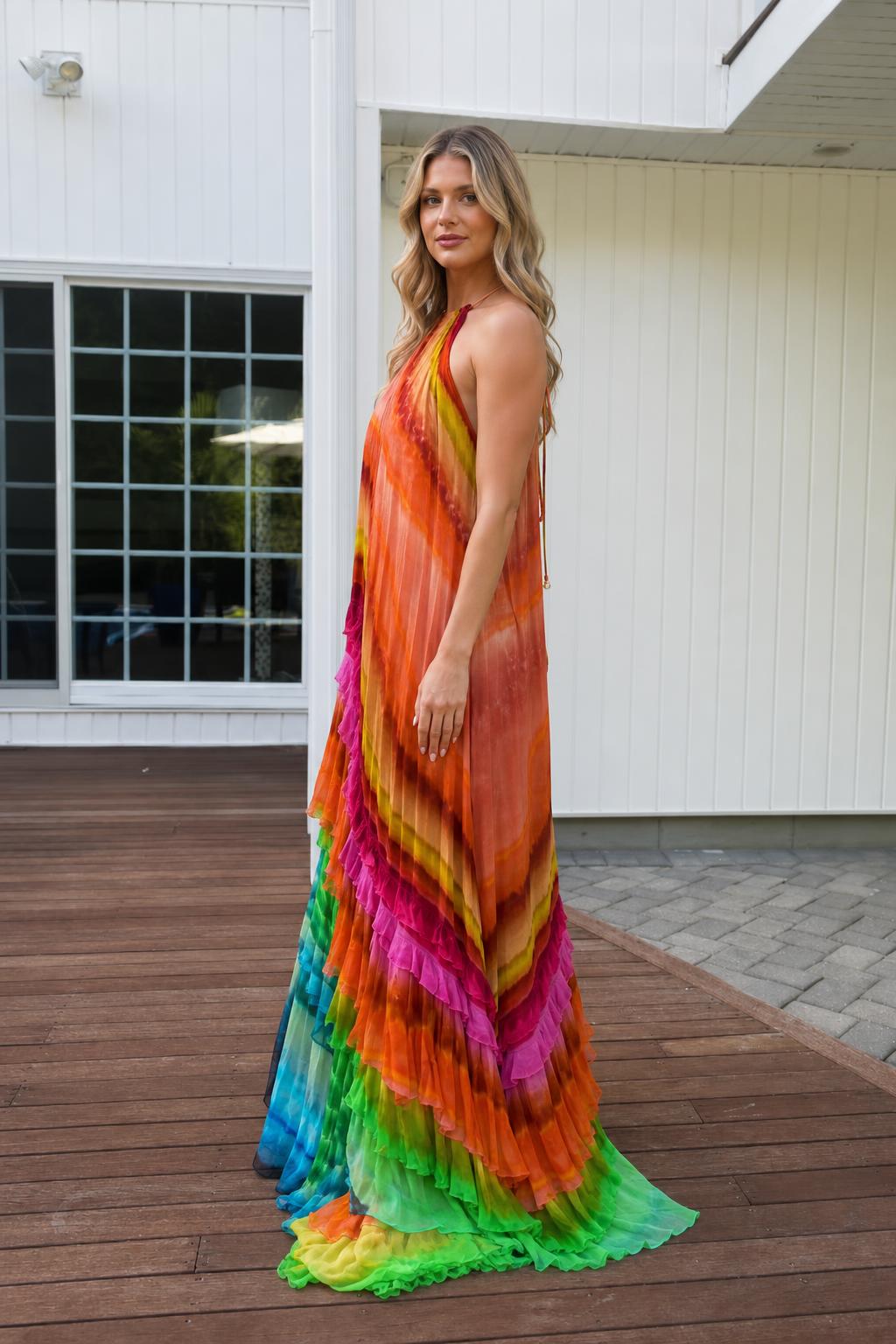 Side profile view of sunset rainbow halter maxi dress