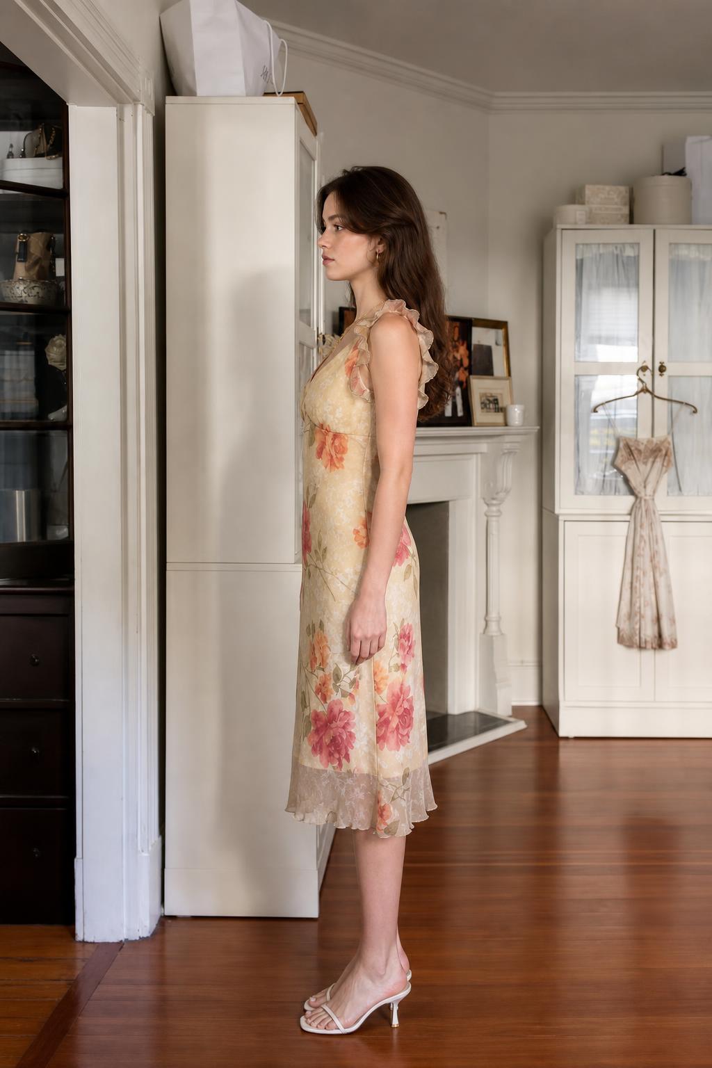 Side profile of woman wearing cream floral midi slip dress