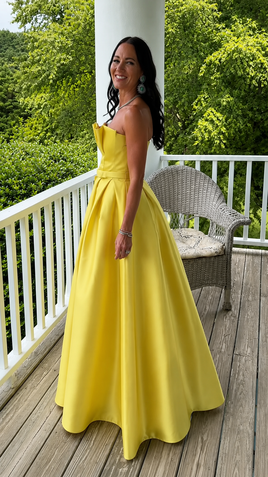 Side view of yellow structured strapless full-length gown