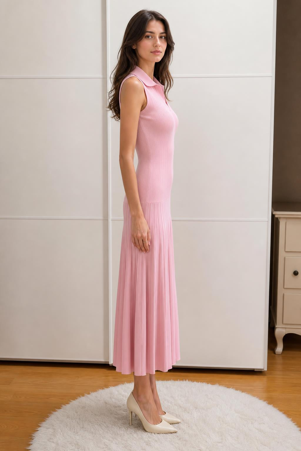 Side profile view of woman in pink knit midi dress