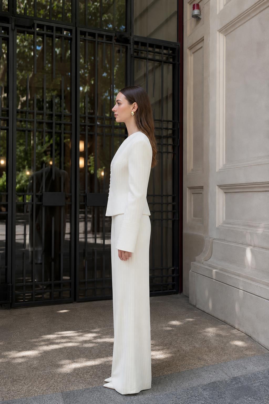 Model wearing white pinstripe suit, side view