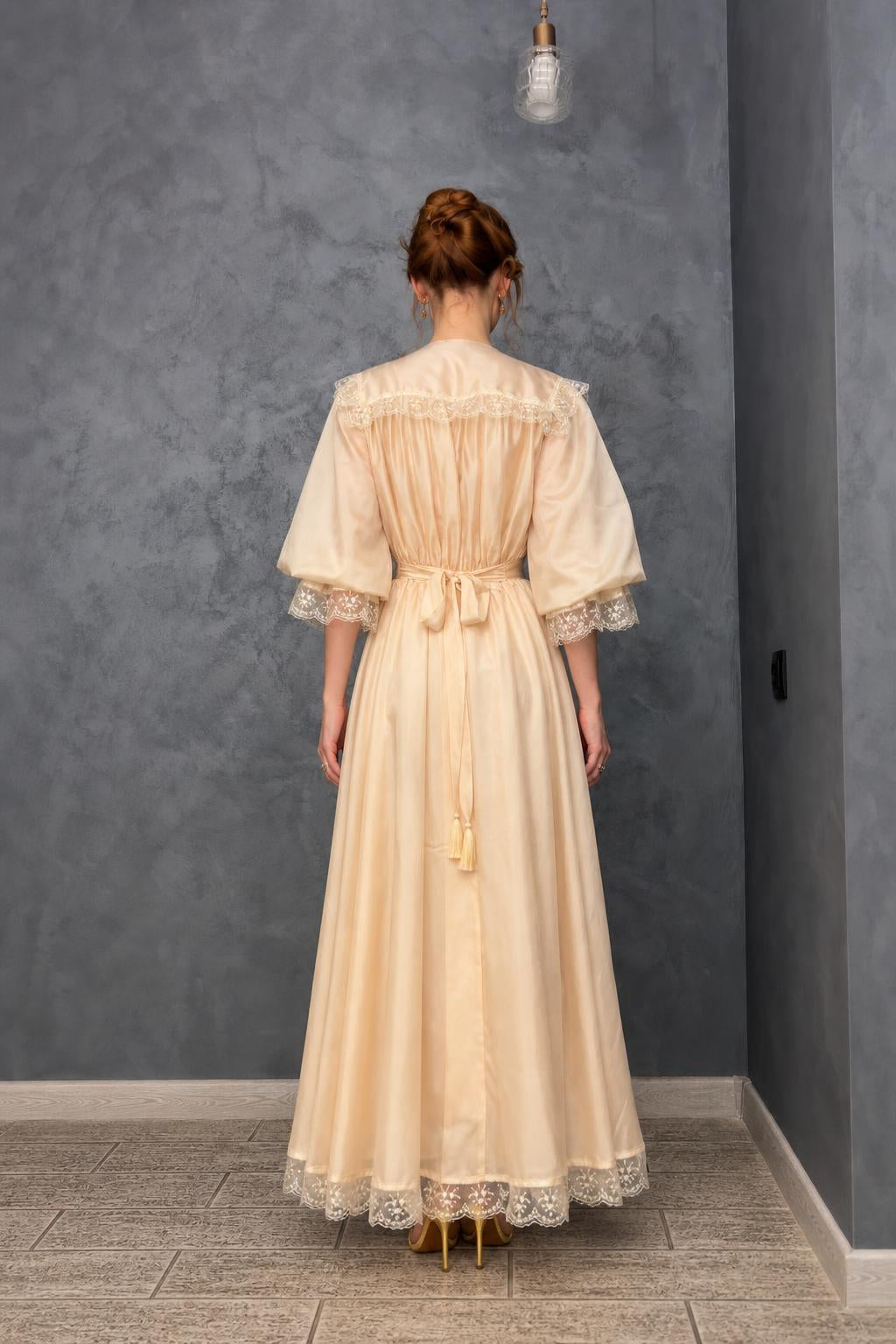 Back view of model in cream maxi dress showing back tie detail
