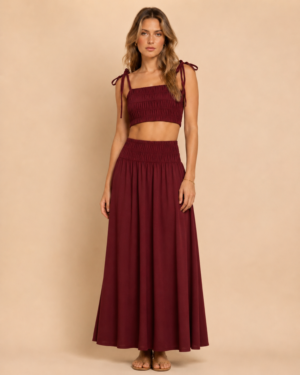 Front view of burgundy smocked tie-shoulder crop top and matching maxi skirt set