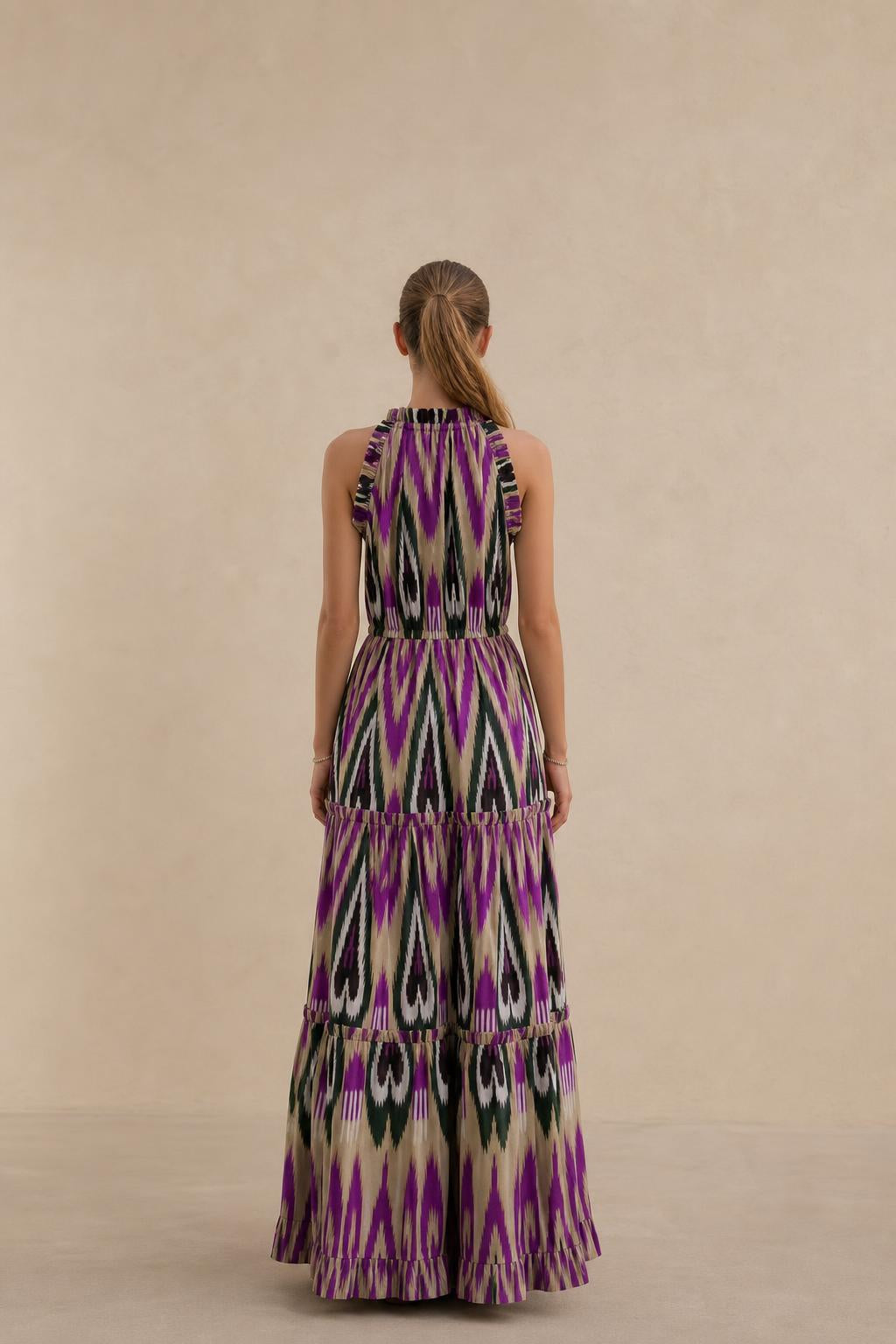 Back view of model in purple multi ikat print maxi dress