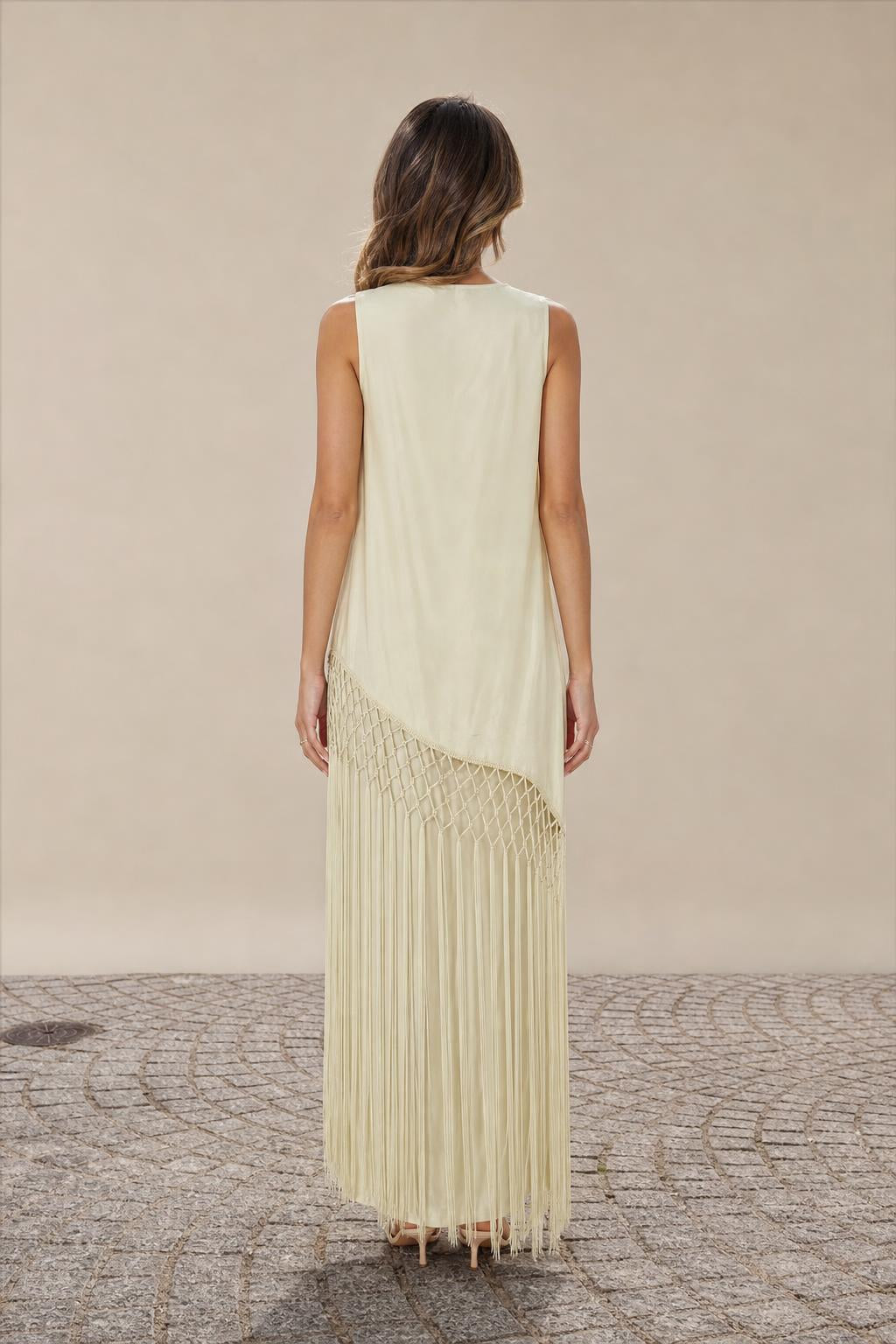 Model wearing Champagne fringe maxi dress back view