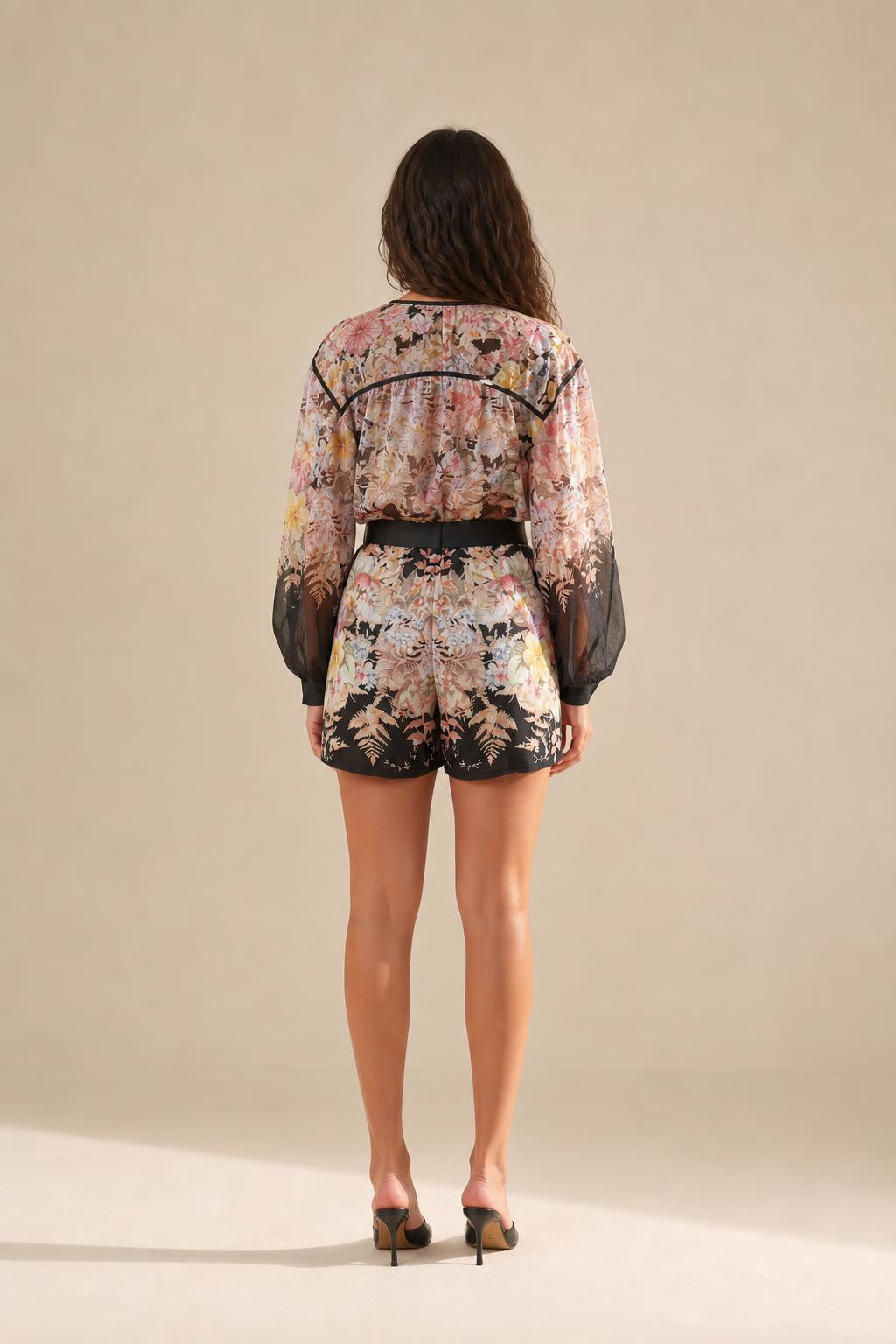 Back view of floral romper showing shorts length and overall fit