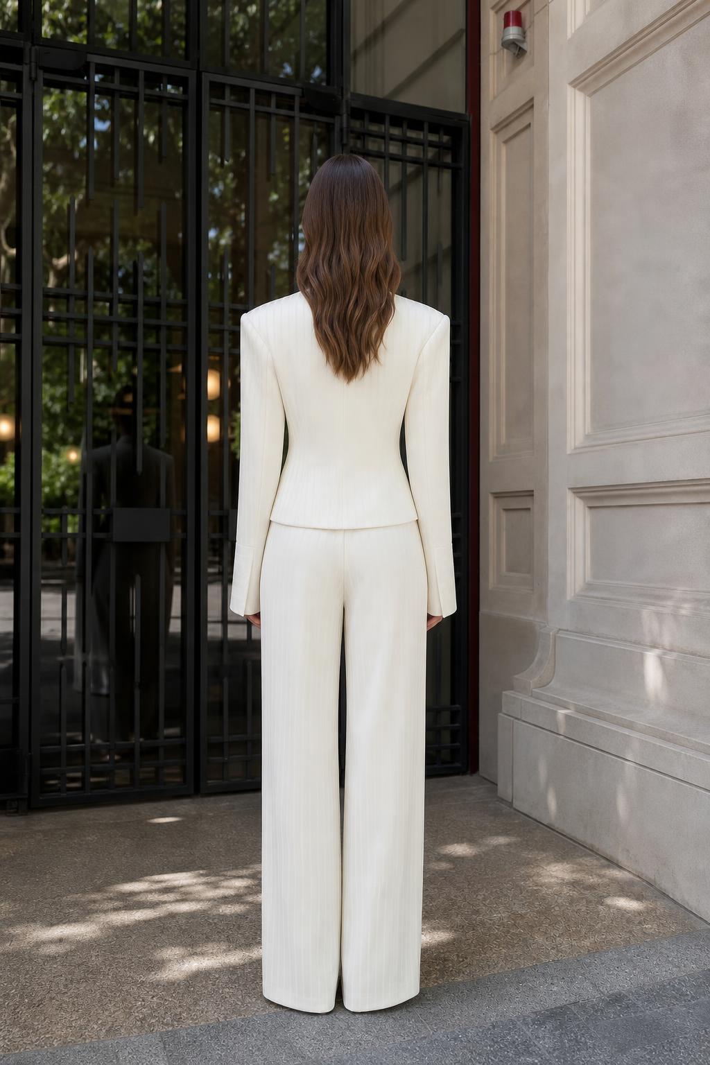 Model wearing white pinstripe suit, back view