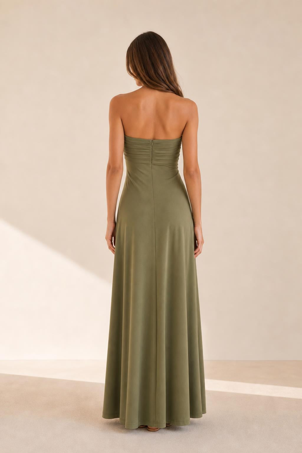 Woman wearing olive green strapless dress back view