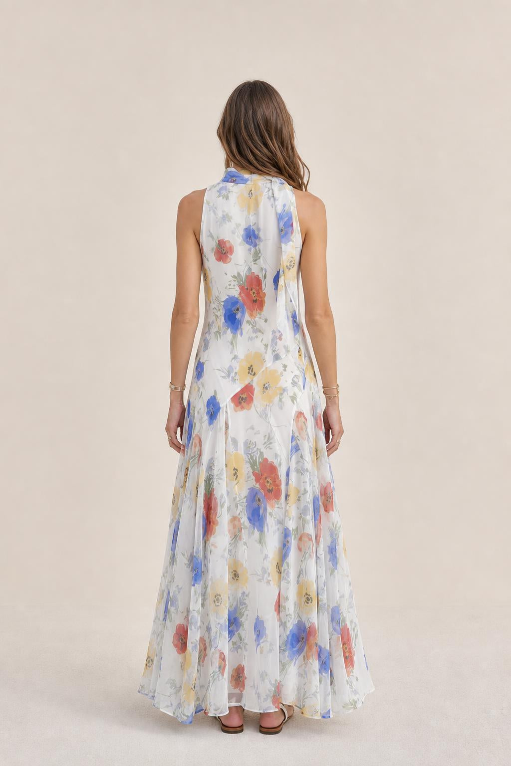 Back view of model in white floral maxi dress