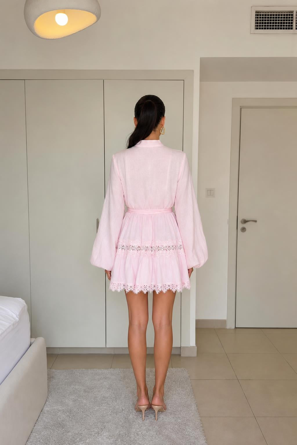Back view of model in pink mini dress