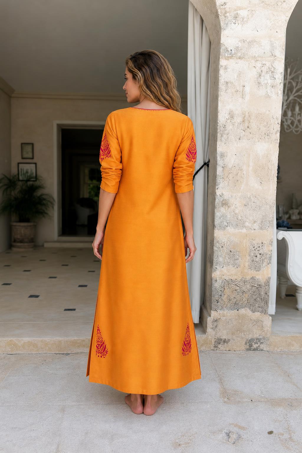 Back view of model in yellow embroidered maxi dress
