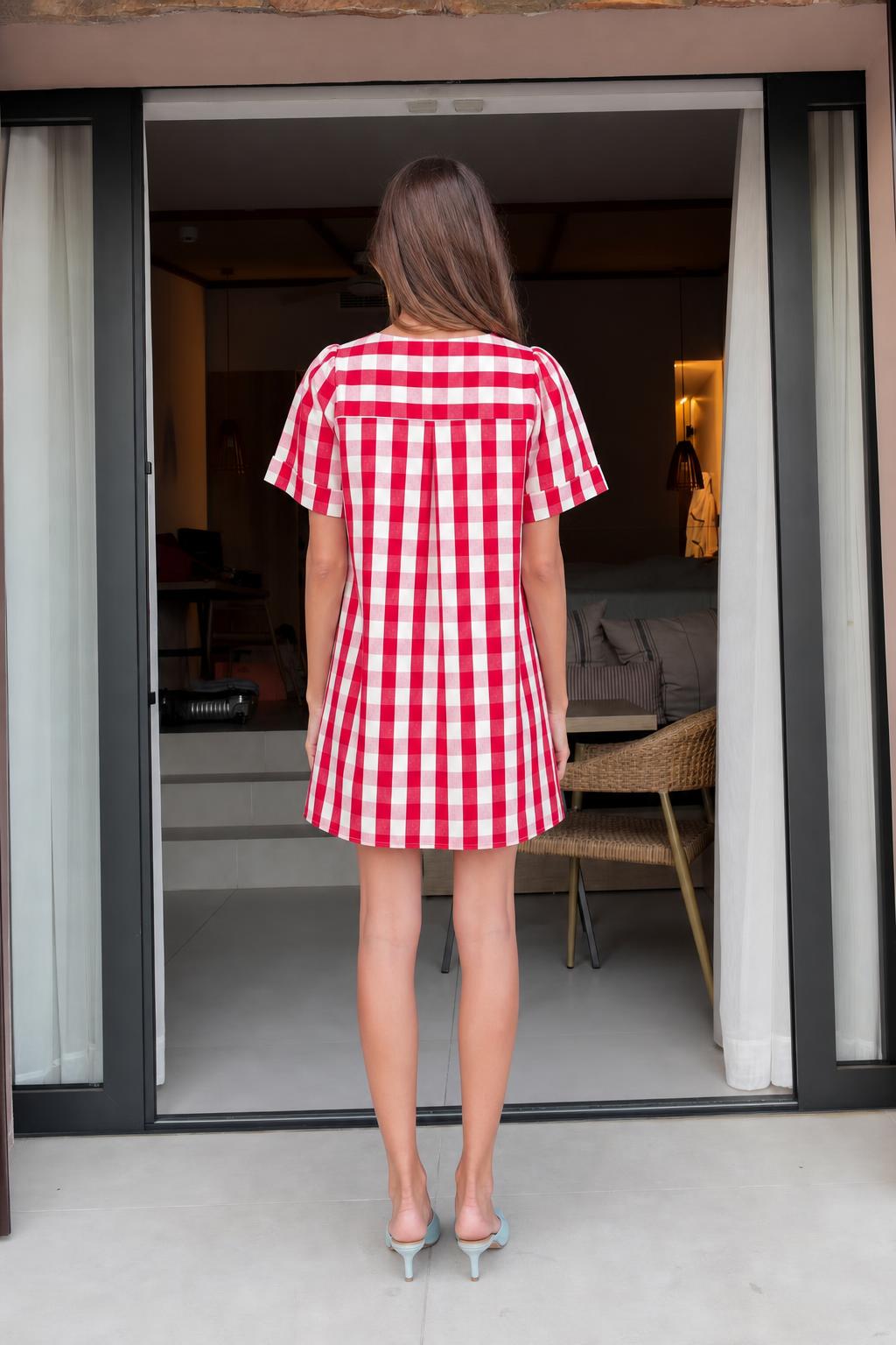 Back view of woman wearing red gingham check mini dress