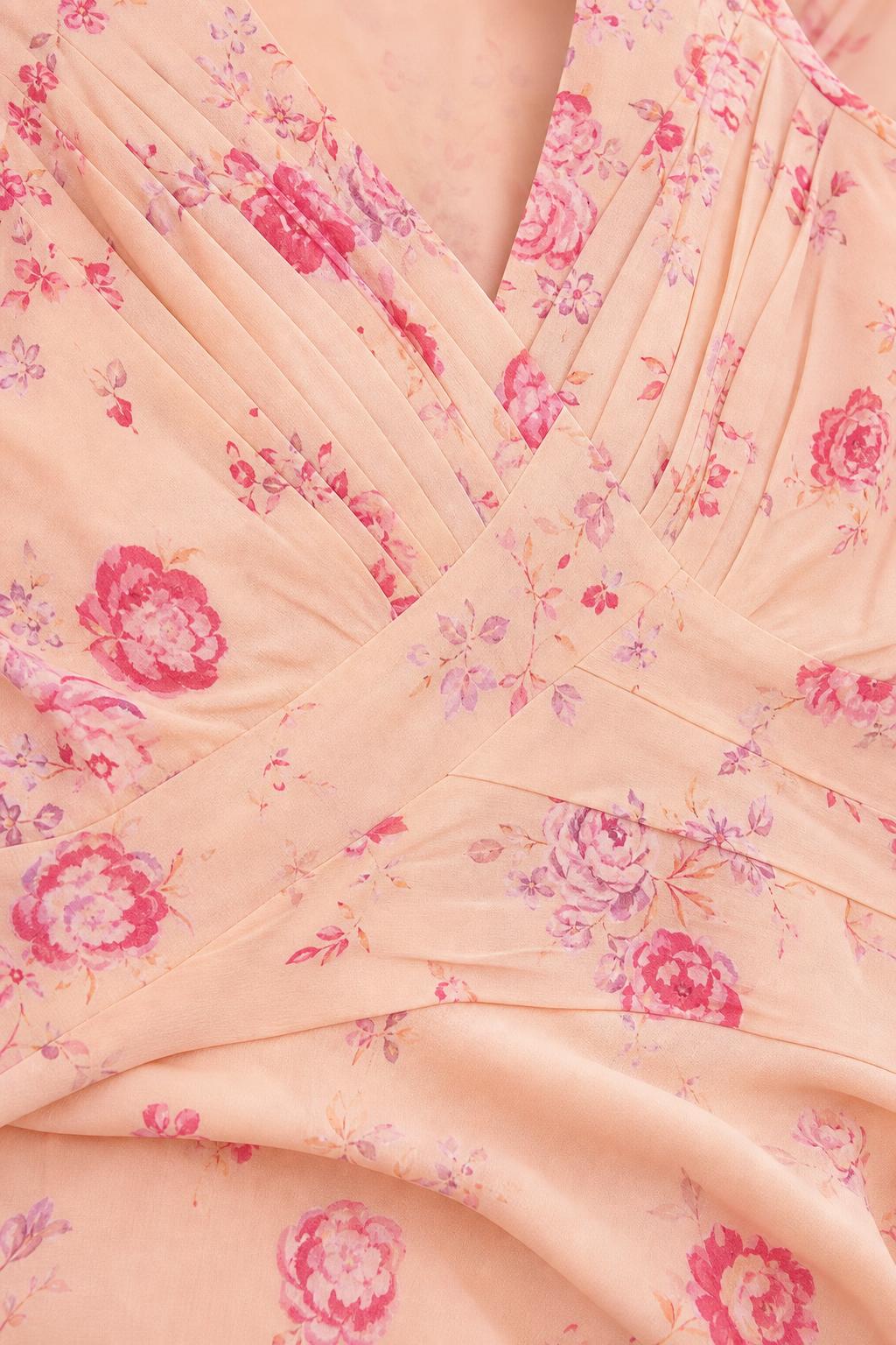 Close-up detail of crossover pleated bodice and floral fabric pattern
