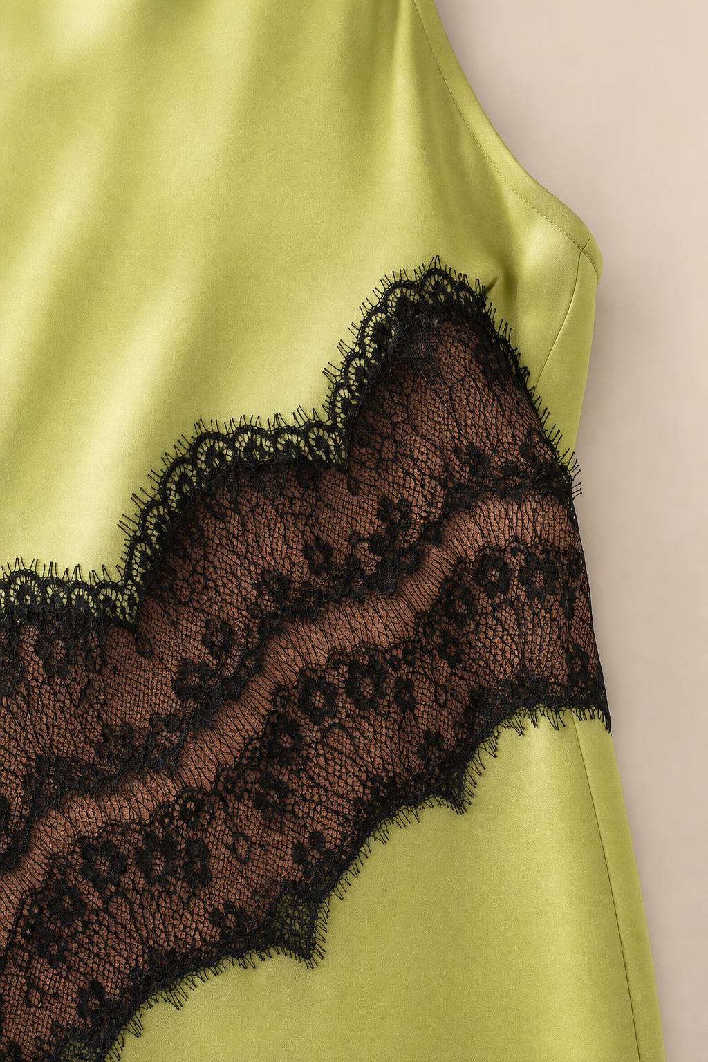 Close-up detail of sheer black lace insert on dress