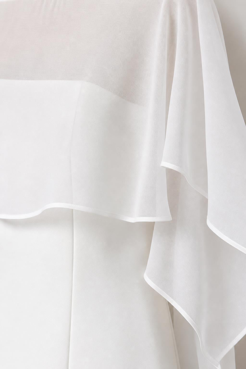 Close-up detail of sheer chiffon cape fabric and layered neckline