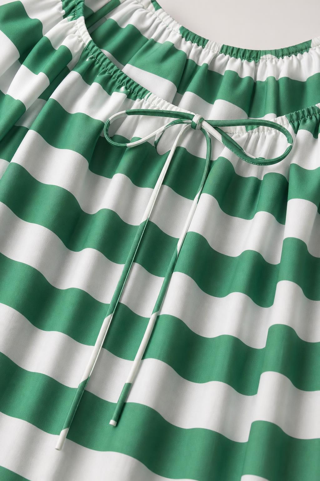 Close up of green and white striped fabric and drawstring neckline