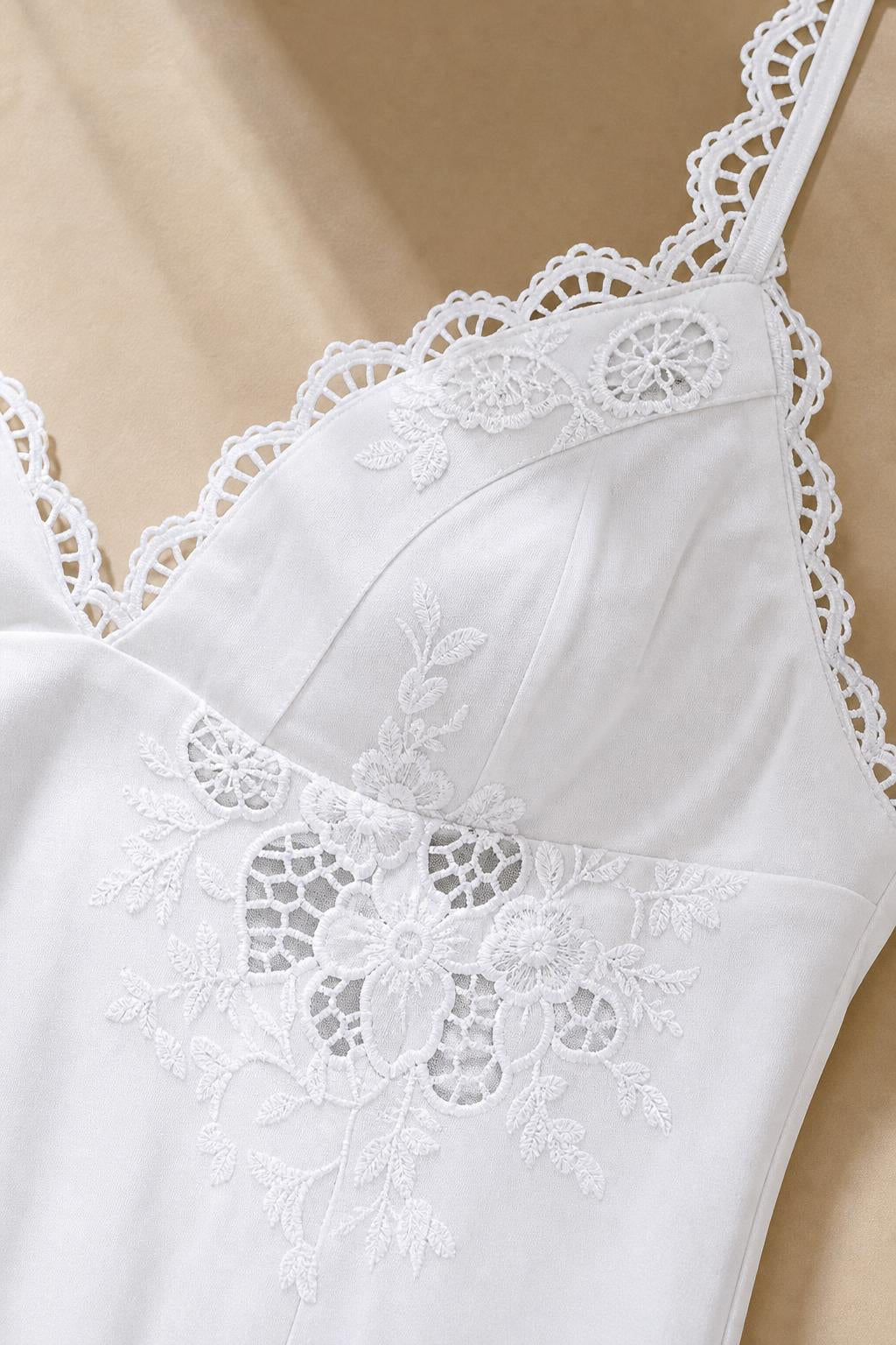 Close-up of embroidered bodice and lace trim on White dress