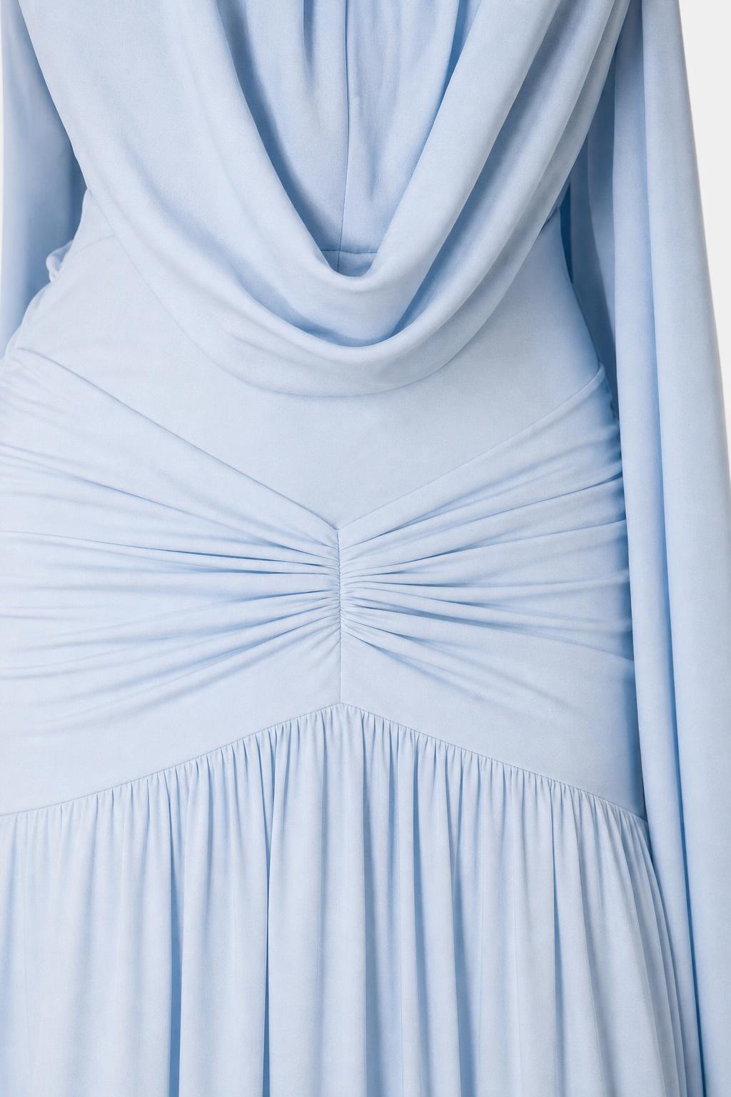 Close-up detail of ruched bodice and draped neckline