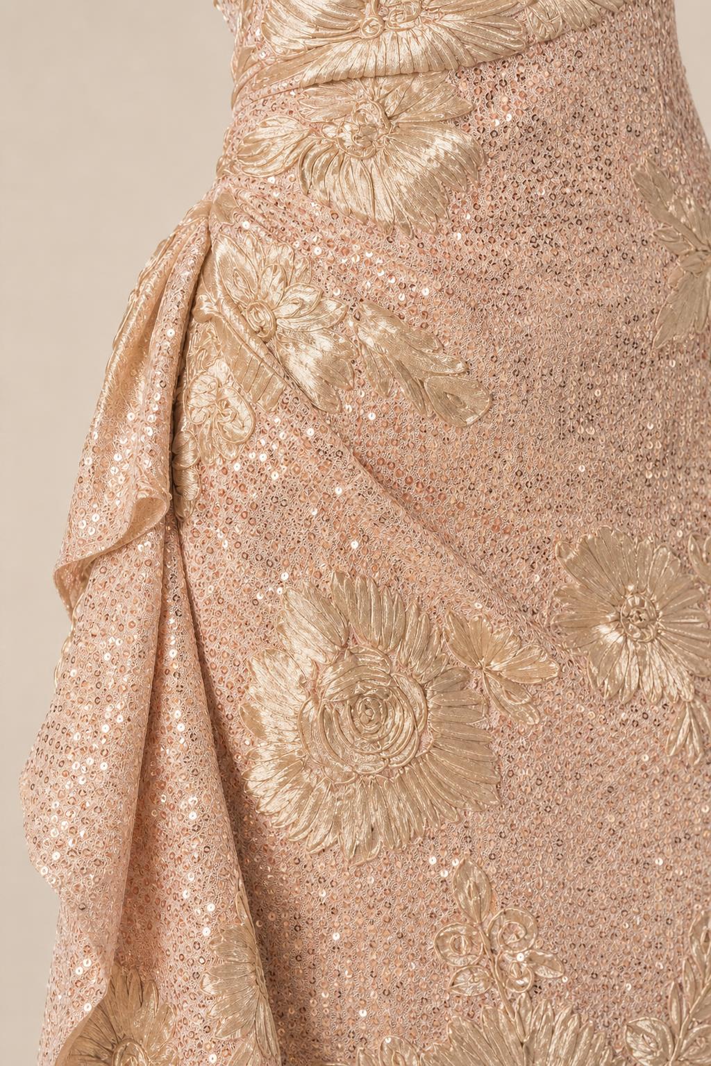 Close-up detail of side ruffle and floral sequin texture on evening gown